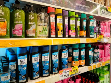 SELANGOR, MALAYSIA -APRIL 6, 2022: Selected focused on the hair shampoo in plastic bottle packaging, on display for sale on the shelves in the supermarket. Tagged with the price tag.