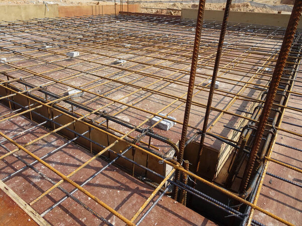 SELANGOR, MALAYSIA -MAY 3, 2022: Steel reinforcement bars for reinforced concrete construction have started to rust after being exposed to weather and water vapor. It can affect rebar if left untreated.