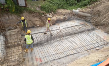 MALACCA, MALAYSIA - SEPTEMBER 24, 2016: Malacca, Malezya 'daki inşaat alanında döşeme destek barı üreten inşaat işçileri.  