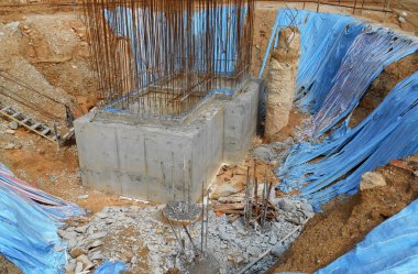 SELANGOR, MALAYSIA - 2 MAYIS 2022: İnşaat çalışması şantiyede yürütülüyor. Bina delik kazık ve kapak metodunu kullanıyor. İşçiler inşaat alanında meşguller..