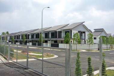 SELANGOR, MALAYSIA -MAY 2, 2022: Selected focused on new double story terrace house under construction in Malaysia. Construction progress is almost complete and almost ready to be occupied.
