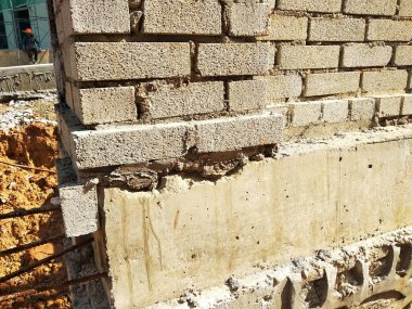 SELANGOR, MALAYSIA -MARCH 5, 2022: Brick installation works at construction sites. Bricks are installed in layers and joined with cement mortar.