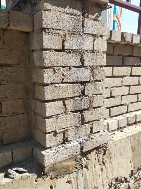 SELANGOR, MALAYSIA -MARCH 5, 2022: Brick installation works at construction sites. Bricks are installed in layers and joined with cement mortar.