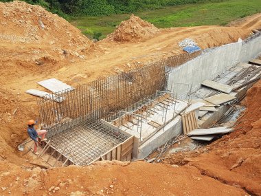 SELANGOR, MALAYSIA - JULY 22, 2021: Retaining wall is under construction. The retaining wall was built according to the engineer's design. The site is excavated to build the foundation structure