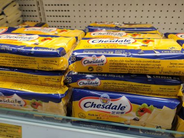 SELANGOR, MALAYSIA -12 APRIL 2022: Sliced cheese placed in commercial packs and displayed for sale. Each pack has several slices of cheese. Separated by brand, type and flavor.
