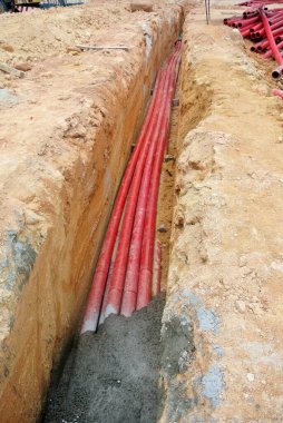 SELANGOR, MALAYSIA -AUGUST 2, 2021: Heavy-duty underground pipes lay in the ground at a construction site. this pipe will be the path to the high voltage electric cable.