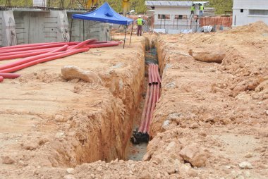 SELANGOR, MALAYSIA -AUGUST 2, 2021: Heavy-duty underground pipes lay in the ground at a construction site. this pipe will be the path to the high voltage electric cable.