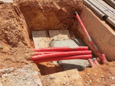 SELANGOR, MALAYSIA -AUGUST 2, 2021: Heavy-duty underground pipes lay in the ground at a construction site. this pipe will be the path to the high voltage electric cable.