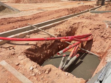 SELANGOR, MALAYSIA -AUGUST 2, 2021: Heavy-duty underground pipes lay in the ground at a construction site. this pipe will be the path to the high voltage electric cable.