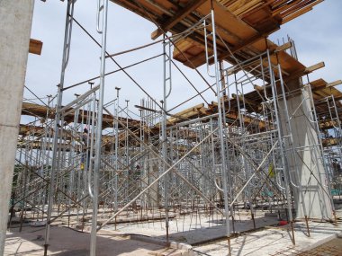 SELANGOR, MALAYSIA -JULY 4, 2021: Scaffolding is installed as temporary support for concrete formwork at the construction site. Installed according to the design approved by the engineer.