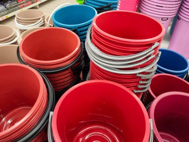 SELANGOR, MALAYSIA -JUNE 9, 2022: Several plastic buckets of various colors and sizes are displayed for sale in a supermarket. Separated according to design and size. Marked with a price tag.
