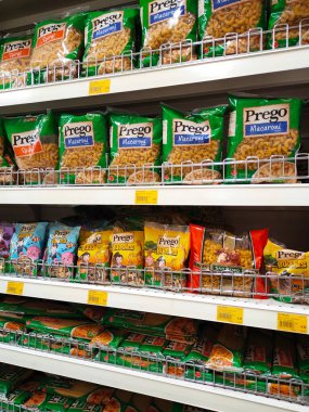 SELANGOR, MALAYSIA -AUGUST 5, 2022: Pasta and macaroni in commercial packs and displayed for sale on shelves. Separated by brand and type. Clearly labeled and has a price tag.