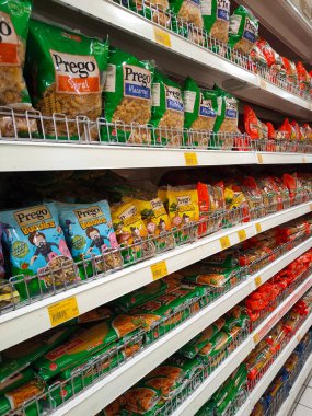 SELANGOR, MALAYSIA -AUGUST 5, 2022: Pasta and macaroni in commercial packs and displayed for sale on shelves. Separated by brand and type. Clearly labeled and has a price tag.