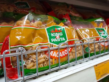 SELANGOR, MALAYSIA -AUGUST 5, 2022: Pasta and macaroni in commercial packs and displayed for sale on shelves. Separated by brand and type. Clearly labeled and has a price tag.