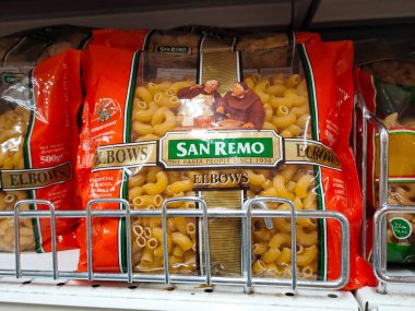 SELANGOR, MALAYSIA -AUGUST 5, 2022: Pasta and macaroni in commercial packs and displayed for sale on shelves. Separated by brand and type. Clearly labeled and has a price tag.