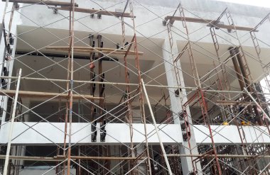 SELANGOR, MALAYSIA -JULY 4, 2021: Scaffolding is installed as temporary support for concrete formwork at the construction site. Installed according to the design approved by the engineer.