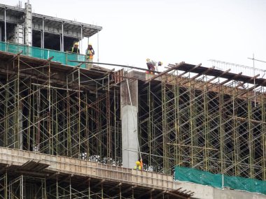 SELANGOR, MALAYSIA -JULY 4, 2021: Scaffolding is installed as temporary support for concrete formwork at the construction site. Installed according to the design approved by the engineer.