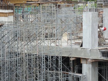 SELANGOR, MALAYSIA -JULY 4, 2021: Scaffolding is installed as temporary support for concrete formwork at the construction site. Installed according to the design approved by the engineer.