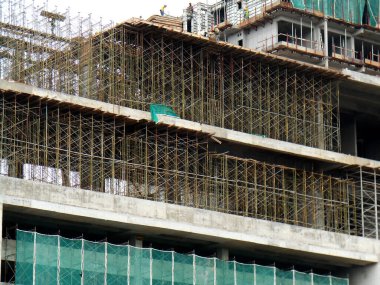 SELANGOR, MALAYSIA -JULY 4, 2021: Scaffolding is installed as temporary support for concrete formwork at the construction site. Installed according to the design approved by the engineer.