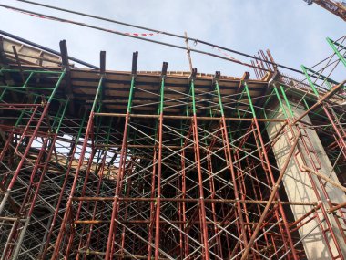 SELANGOR, MALAYSIA -JULY 4, 2021: Scaffolding is installed as temporary support for concrete formwork at the construction site. Installed according to the design approved by the engineer.