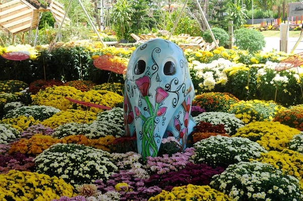 SELANGOR, MALAYSIA -JULY 2, 2022: Various species of tropical flowers are planted in a flower garden. The flowers are arranged and mixed according to the design and theme.