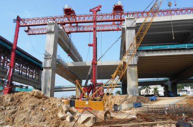 SELANGOR, MALAYSIA -JUNE 30, 2022: Bore pile rig machine at the construction site. The machine used to driven pile for building foundation work. Operated by skilled workers. Heavy machinery.