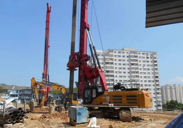 SELANGOR, MALAYSIA -JUNE 30, 2022: Bore pile rig machine at the construction site. The machine used to driven pile for building foundation work. Operated by skilled workers. Heavy machinery.