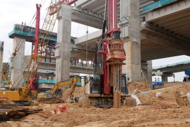 SELANGOR, MALAYSIA -JUNE 30, 2022: Bore pile rig machine at the construction site. The machine used to driven pile for building foundation work. Operated by skilled workers. Heavy machinery.