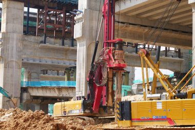 SELANGOR, MALAYSIA -JUNE 30, 2022: Bore pile rig machine at the construction site. The machine used to driven pile for building foundation work. Operated by skilled workers. Heavy machinery.