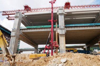 SELANGOR, MALAYSIA -JUNE 30, 2022: Bore pile rig machine at the construction site. The machine used to driven pile for building foundation work. Operated by skilled workers. Heavy machinery.