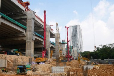 SELANGOR, MALAYSIA -JUNE 30, 2022: Bore pile rig machine at the construction site. The machine used to driven pile for building foundation work. Operated by skilled workers. Heavy machinery.