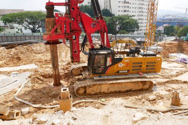 SELANGOR, MALAYSIA -JUNE 30, 2022: Bore pile rig machine at the construction site. The machine used to driven pile for building foundation work. Operated by skilled workers. Heavy machinery.