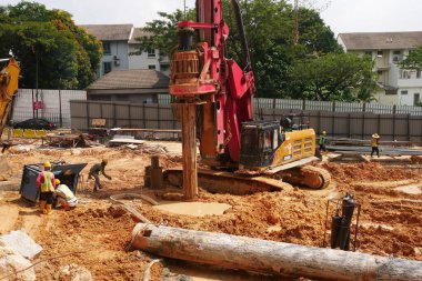 SELANGOR, MALAYSIA -JUNE 30, 2022: Bore pile rig machine at the construction site. The machine used to driven pile for building foundation work. Operated by skilled workers. Heavy machinery.