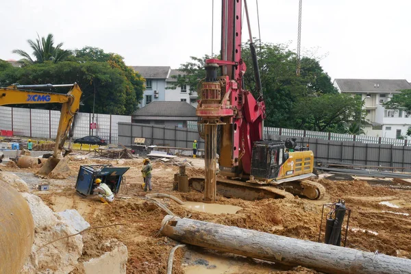 SELANGOR, MALAYSIA -JUNE 30, 2022: Bore pile rig machine at the construction site. The machine used to driven pile for building foundation work. Operated by skilled workers. Heavy machinery.