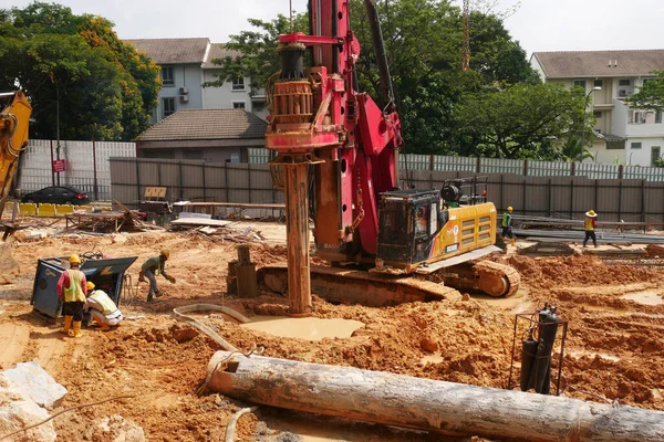 SELANGOR, MALAYSIA -JUNE 30, 2022: Bore pile rig machine at the construction site. The machine used to driven pile for building foundation work. Operated by skilled workers. Heavy machinery.