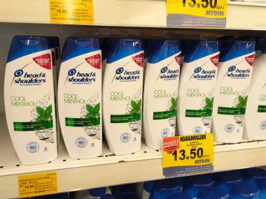SELANGOR, MALAYSIA -JUNE 6, 2022: Selected focused on the hair shampoo in plastic bottle packaging, on display for sale on the shelves in the supermarket. Tagged with the price tag.