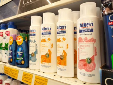 SELANGOR, MALAYSIA -JUNE 6, 2022: Selected focused on the hair shampoo in plastic bottle packaging, on display for sale on the shelves in the supermarket. Tagged with the price tag.