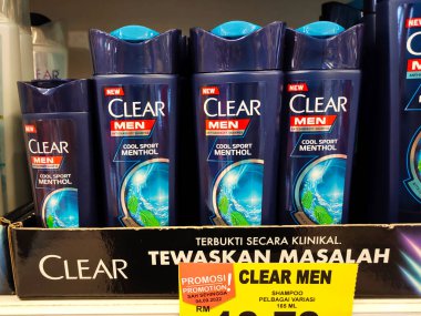 SELANGOR, MALAYSIA -JUNE 6, 2022: Selected focused on the hair shampoo in plastic bottle packaging, on display for sale on the shelves in the supermarket. Tagged with the price tag.