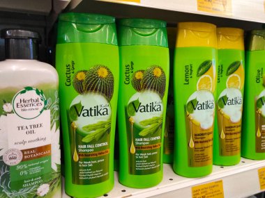 SELANGOR, MALAYSIA -JUNE 6, 2022: Selected focused on the hair shampoo in plastic bottle packaging, on display for sale on the shelves in the supermarket. Tagged with the price tag.