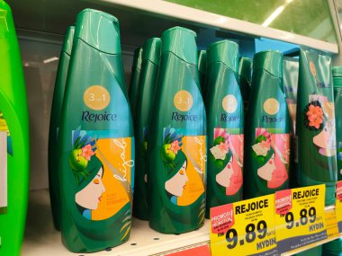 SELANGOR, MALAYSIA -JUNE 6, 2022: Selected focused on the hair shampoo in plastic bottle packaging, on display for sale on the shelves in the supermarket. Tagged with the price tag.