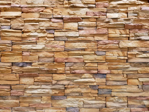 Artificial stone cladding. Designed to resemble real stone. Arranged vertically and attached to the wall with a special adhesive. Used as decoration on the walls of buildings.