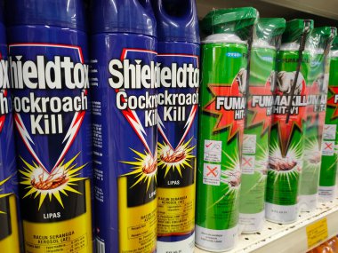 SEREMBAN, MALAYSIA -JUNE 6, 2022: Various brands of aerosol-type insecticides in commercial cans. Displayed for sale. Labeled with a price tag.