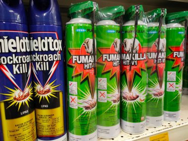SEREMBAN, MALAYSIA -JUNE 6, 2022: Various brands of aerosol-type insecticides in commercial cans. Displayed for sale. Labeled with a price tag.