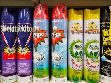SEREMBAN, MALAYSIA -JUNE 6, 2022: Various brands of aerosol-type insecticides in commercial cans. Displayed for sale. Labeled with a price tag.