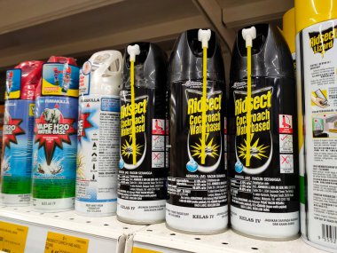 SEREMBAN, MALAYSIA -JUNE 6, 2022: Various brands of aerosol-type insecticides in commercial cans. Displayed for sale. Labeled with a price tag.