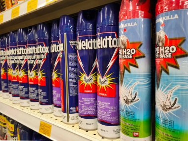 SEREMBAN, MALAYSIA -JUNE 6, 2022: Various brands of aerosol-type insecticides in commercial cans. Displayed for sale. Labeled with a price tag.