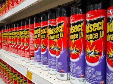 SEREMBAN, MALAYSIA -JUNE 6, 2022: Various brands of aerosol-type insecticides in commercial cans. Displayed for sale. Labeled with a price tag.