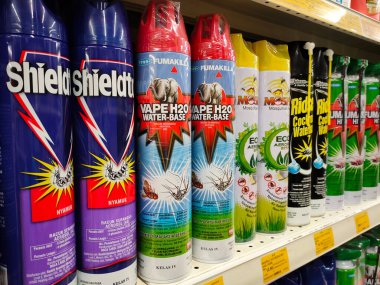 SEREMBAN, MALAYSIA -JUNE 6, 2022: Various brands of aerosol-type insecticides in commercial cans. Displayed for sale. Labeled with a price tag.