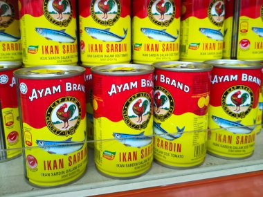 SELANGOR, MALAYSIA -JULY 6, 2022: Selective focused on sardine fish can. The fish has been processed, cook and packed in the can. Displayed on the rack for sale and tag with the price tag