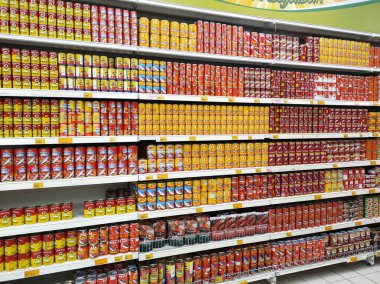 SELANGOR, MALAYSIA -JULY 6, 2022: Selective focused on sardine fish can. The fish has been processed, cook and packed in the can. Displayed on the rack for sale and tag with the price tag